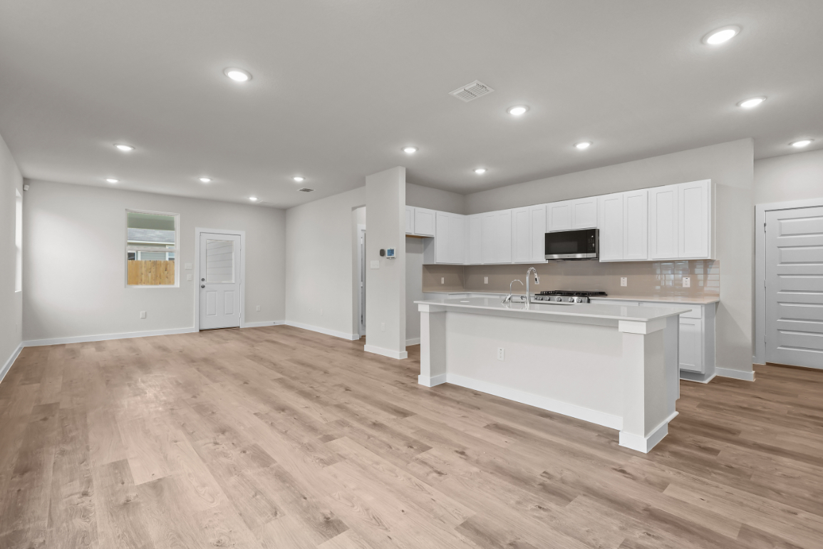 A kitchen with white cabinets.