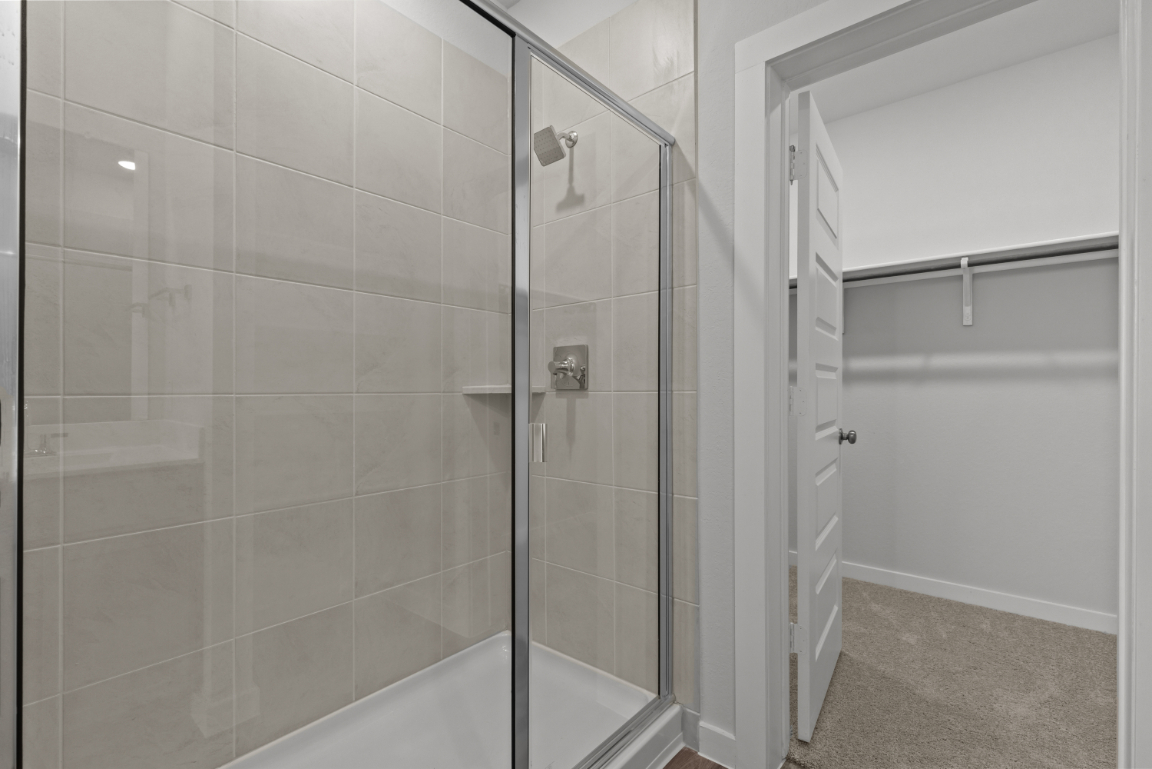 A shower with a glass door.