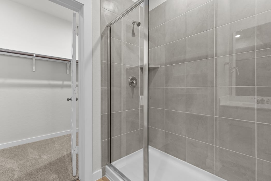 A shower with a glass door.