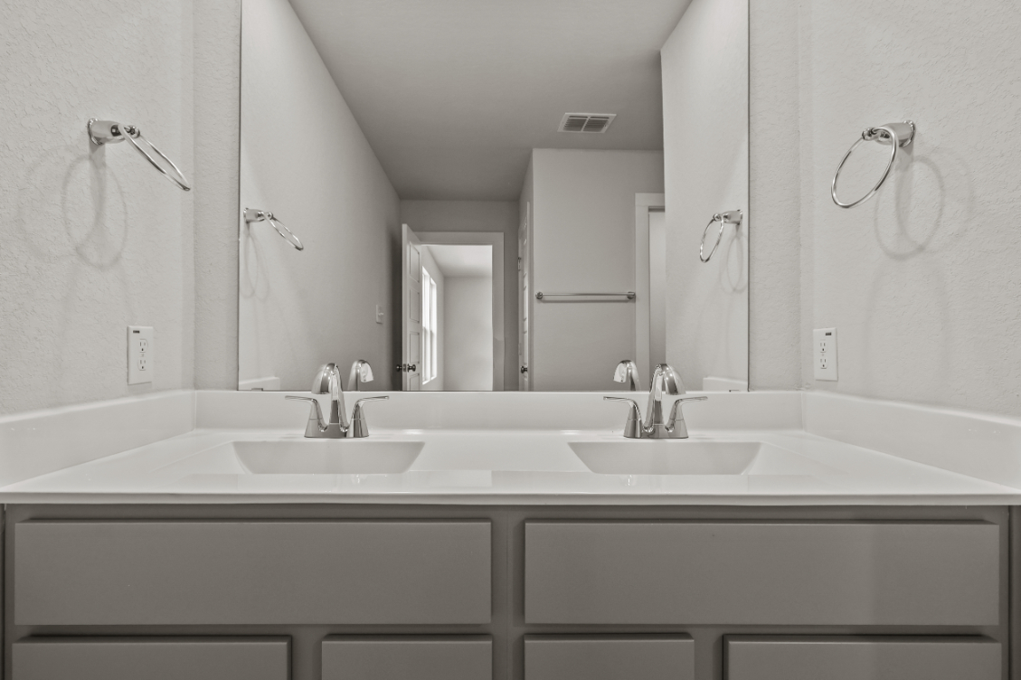 A bathroom with a couple of sinks.