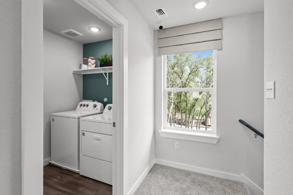 A white kitchen with a window.