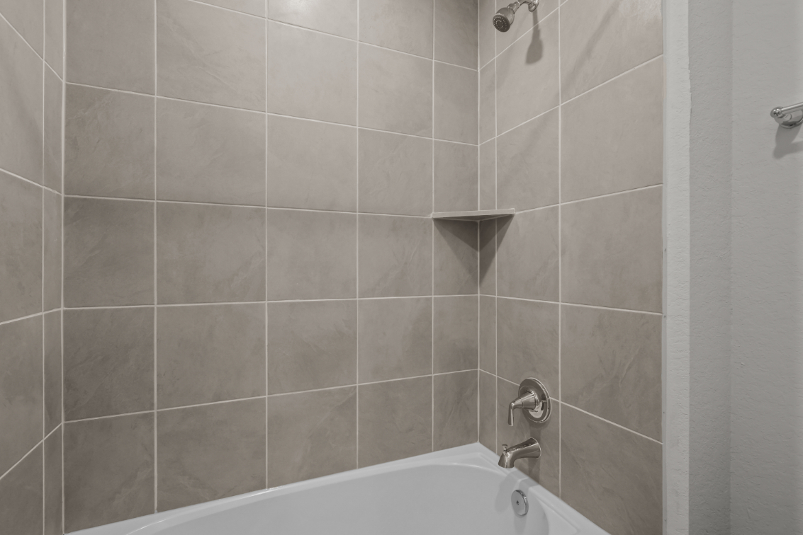 A bathtub in a bathroom.