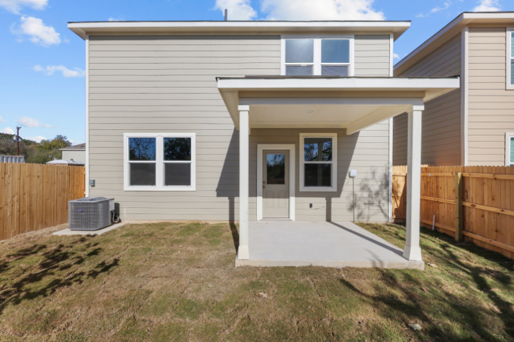 A house with a fence and a yard.