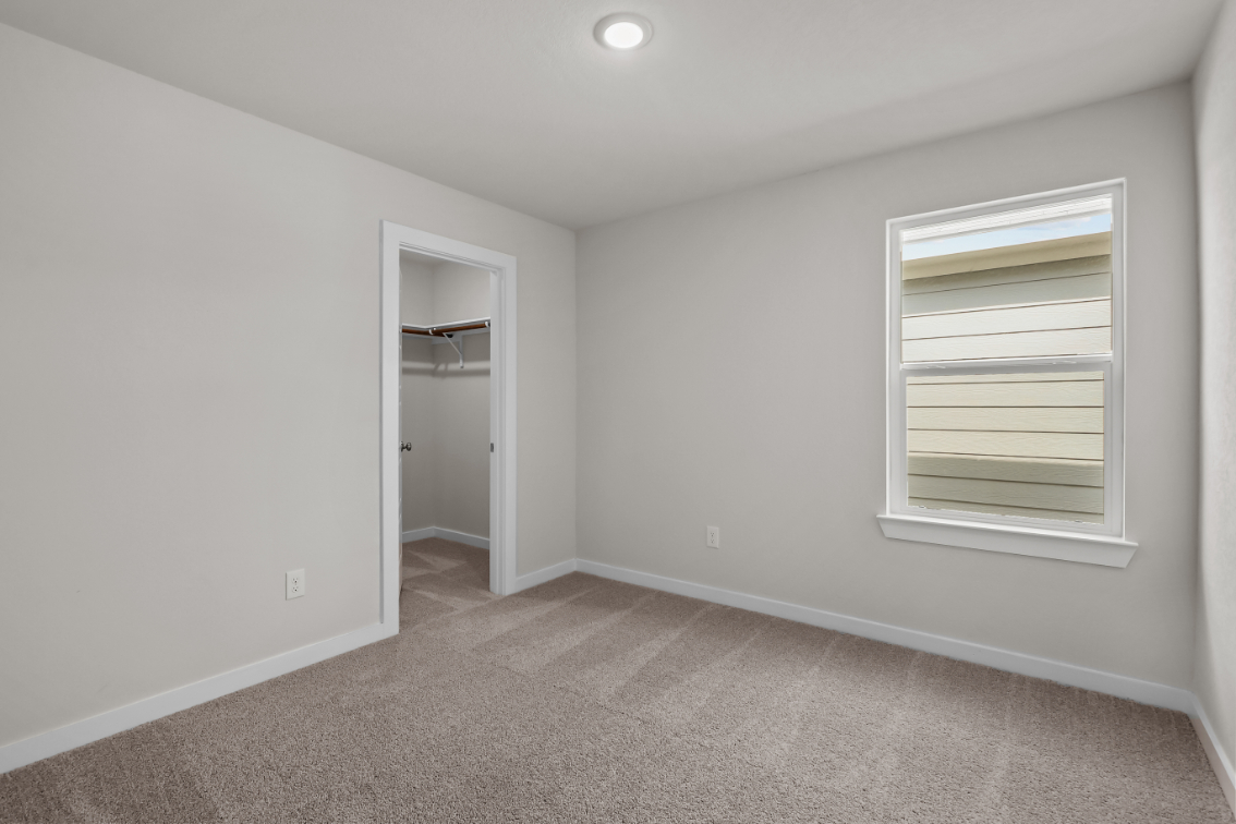 A room with a window and a door.