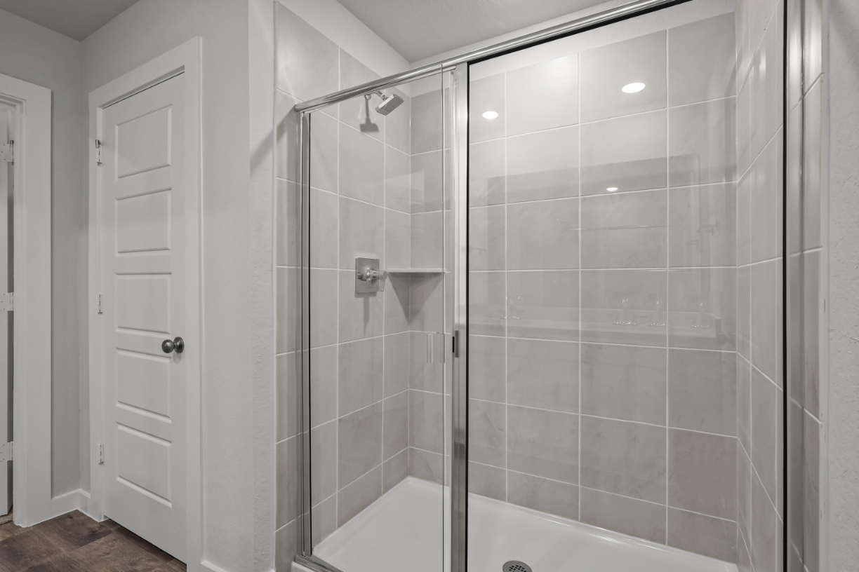 A shower with a glass door.