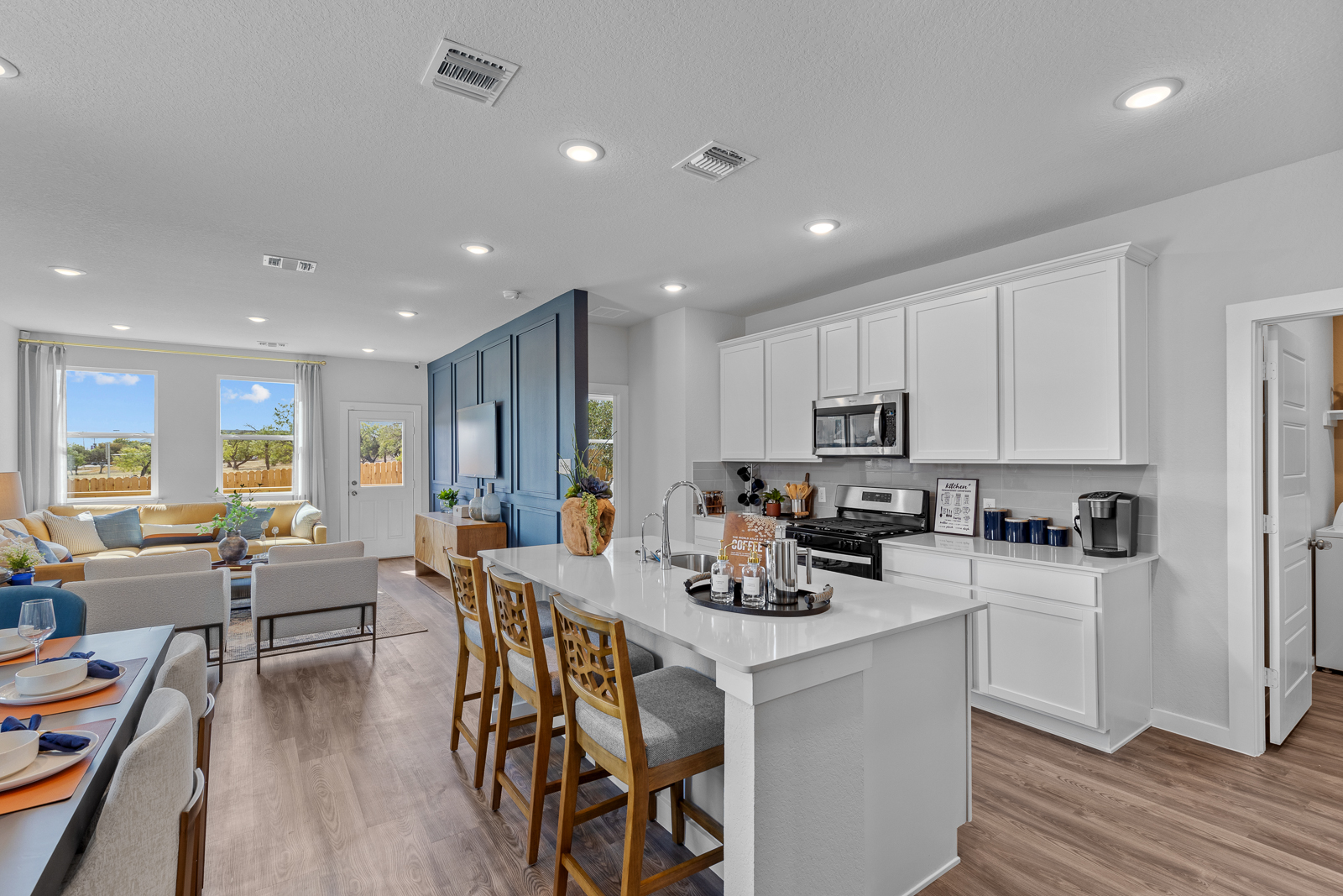 A kitchen with white cabinets.