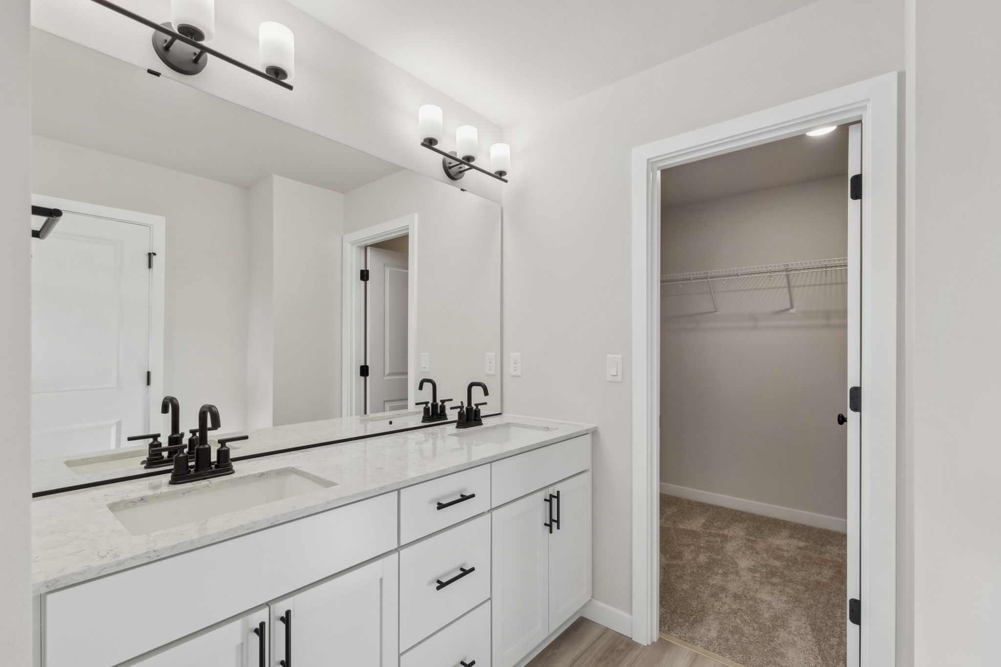 A bathroom with a shower and sink.