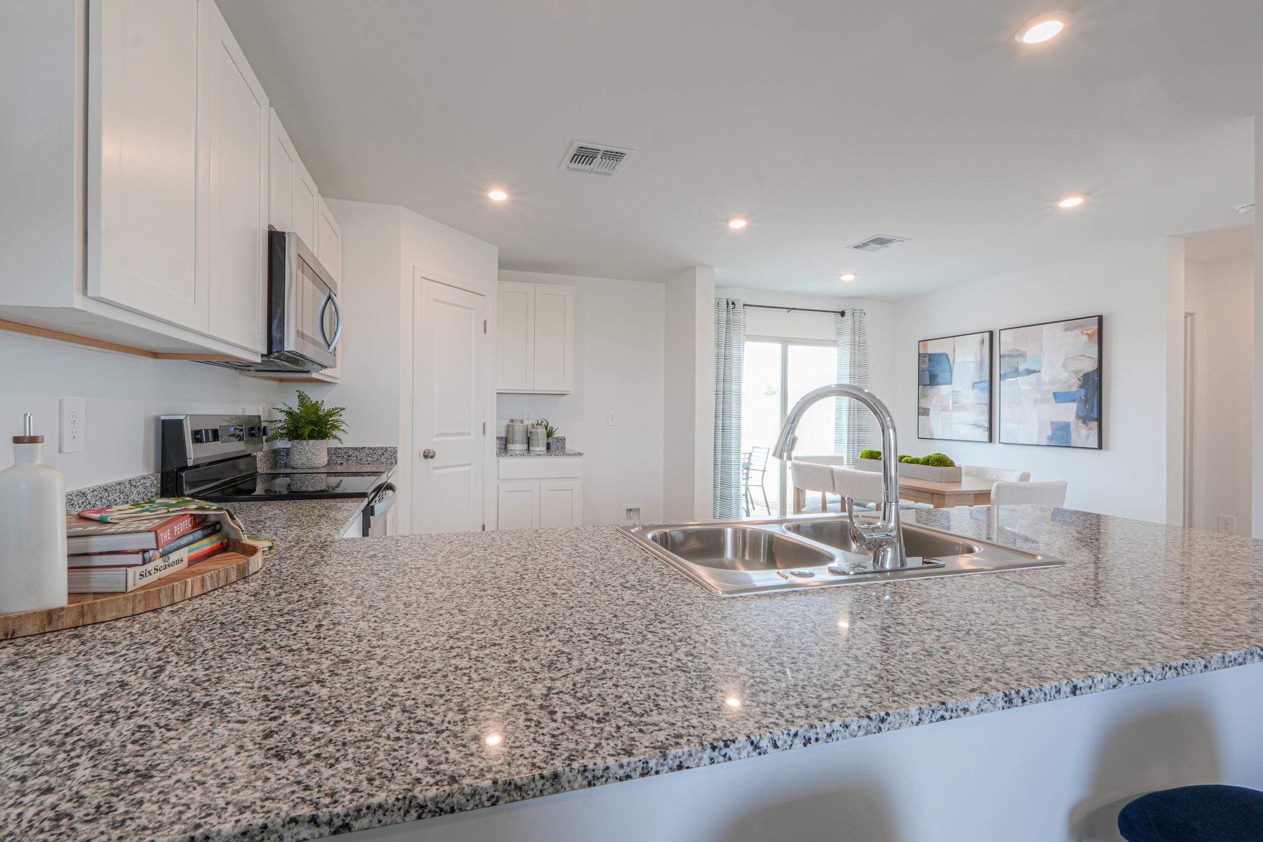 A kitchen with marble counters.