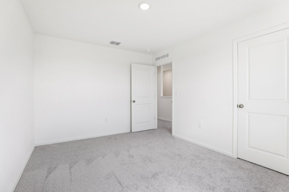 A hallway with white doors.