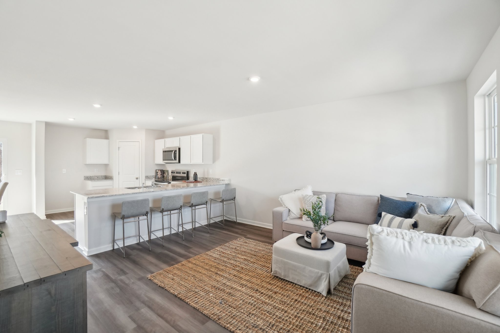 A living room with a dining table and couches.