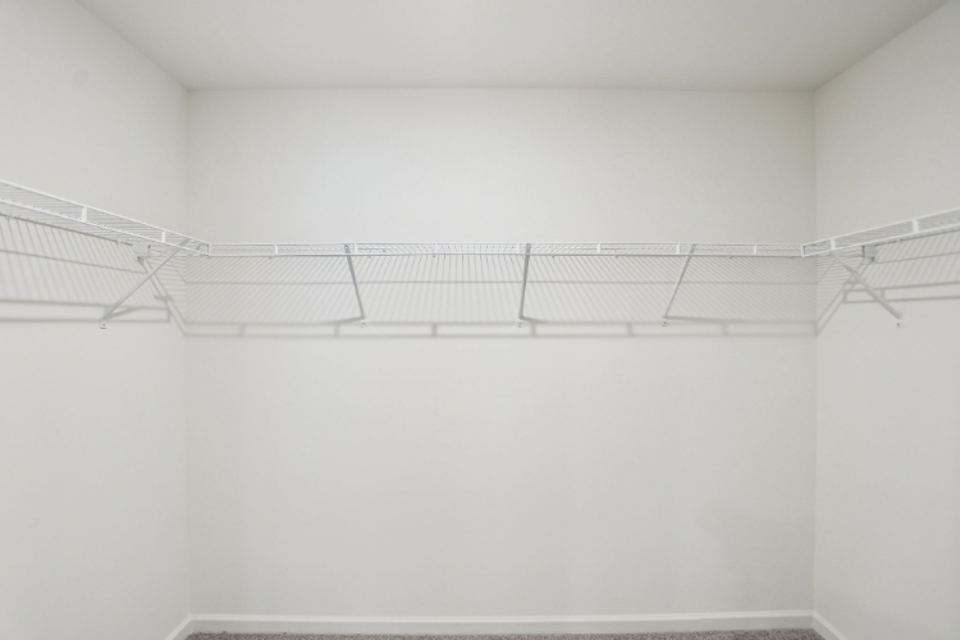 A white wall with a metal railing.