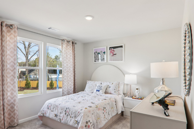 A bedroom with a large window.