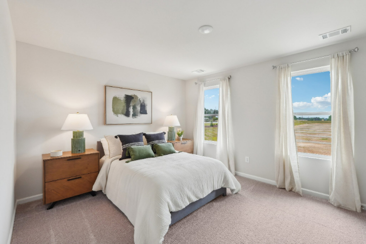 A bedroom with a large window.