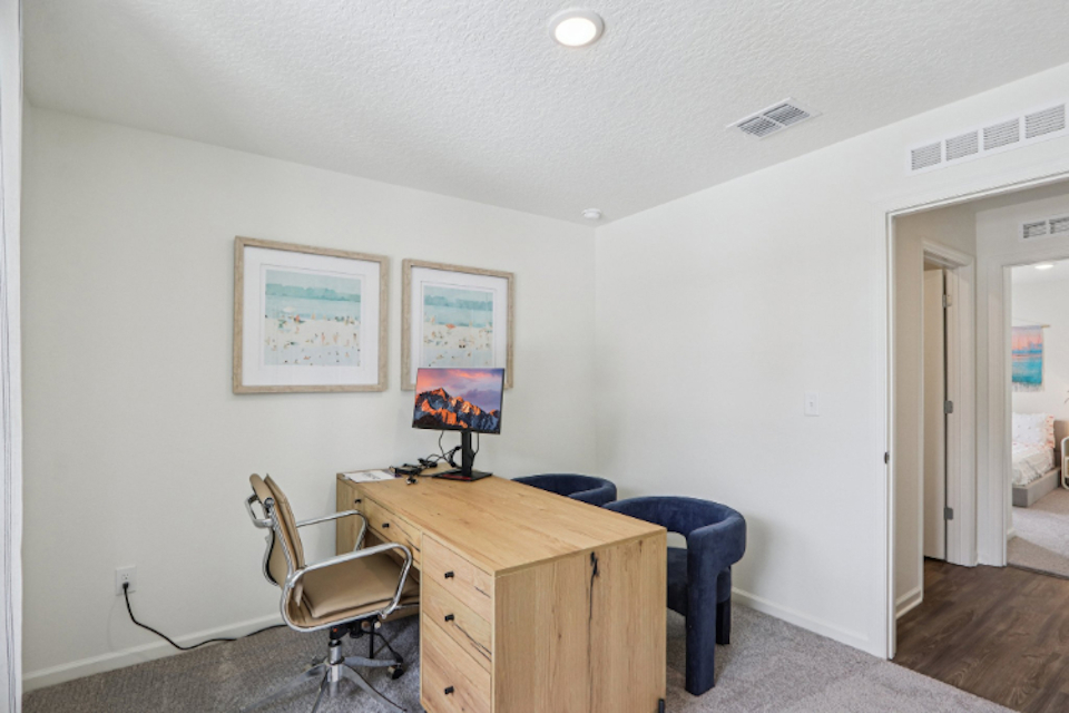 A room with a desk and a chair.