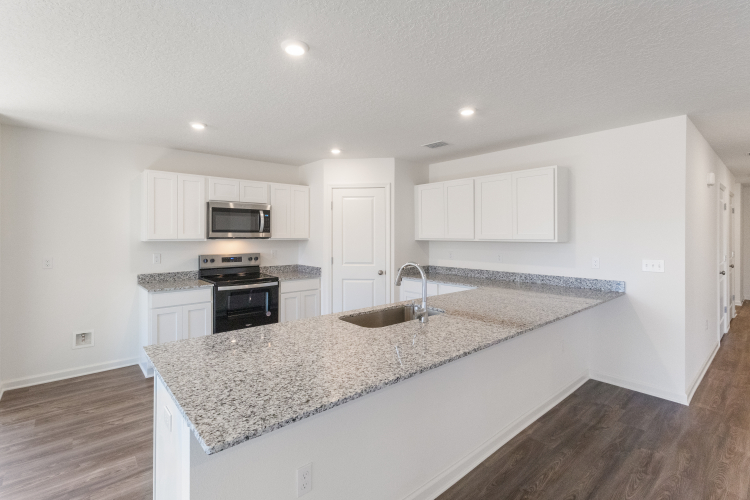 A kitchen with marble counters.