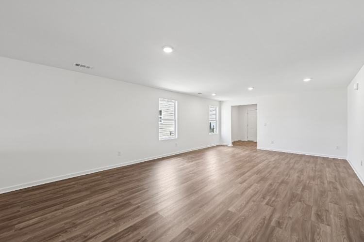 A room with a wood floor and white walls.