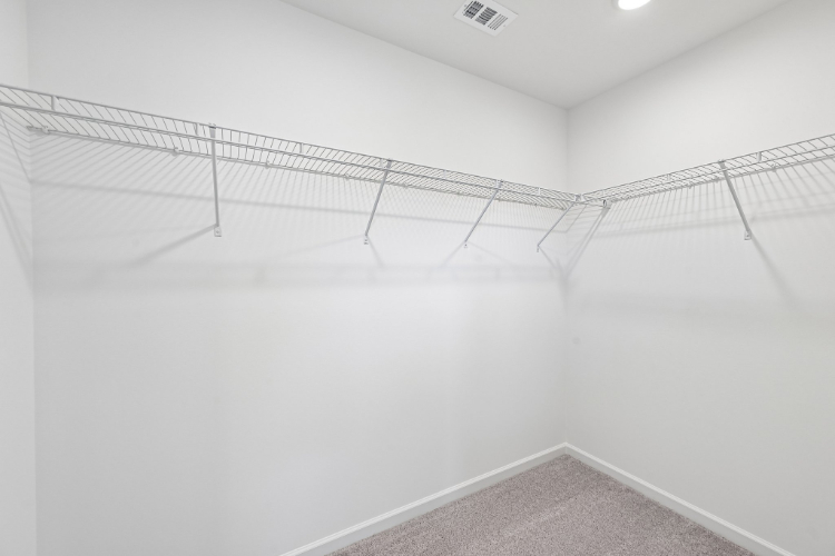 A white wall with a metal railing.