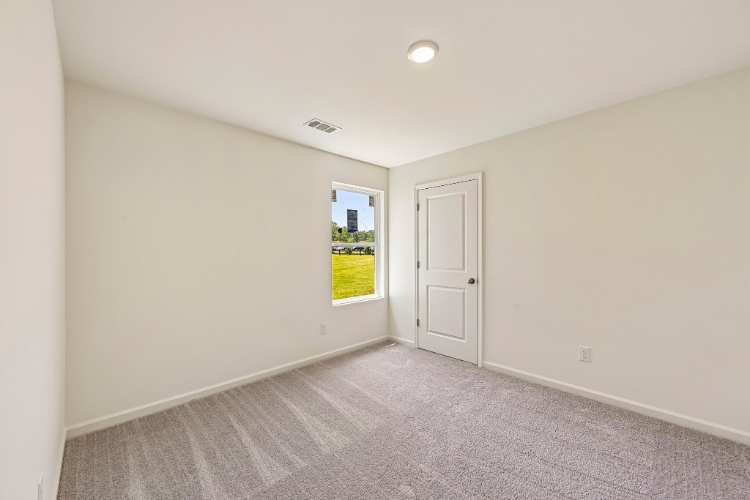 A hallway with a door and a window.