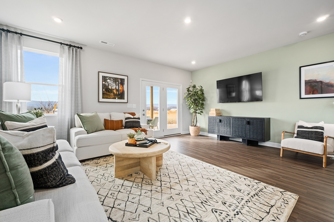 A living room with a wood floor.