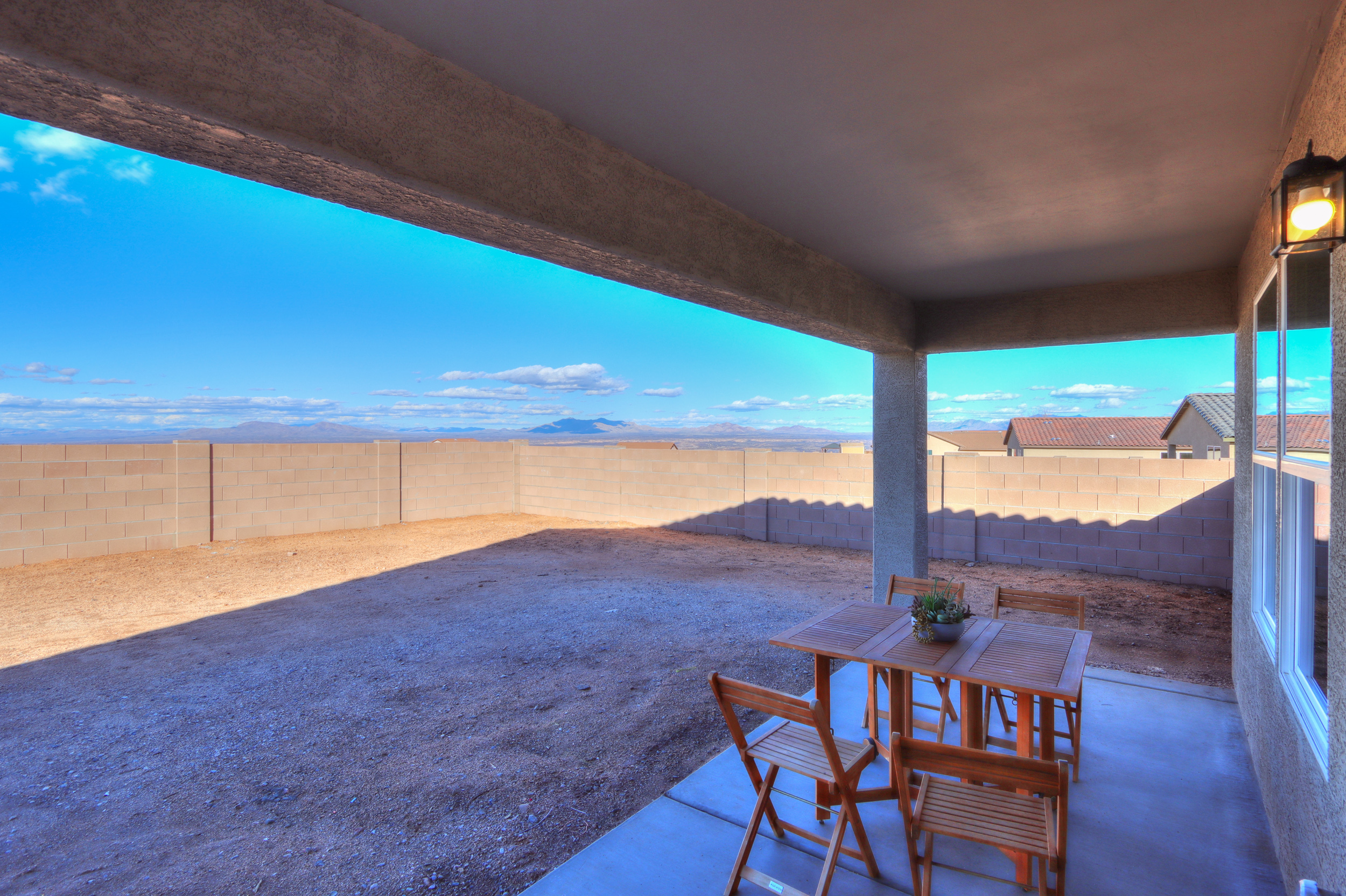 A table and chairs on a deck.