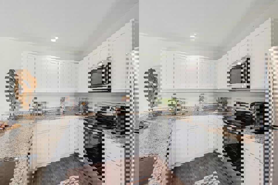 A kitchen with white cabinets.