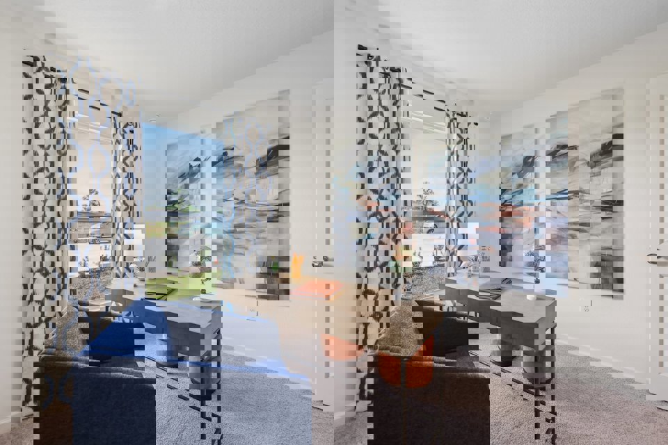 A room with a desk and a chair.