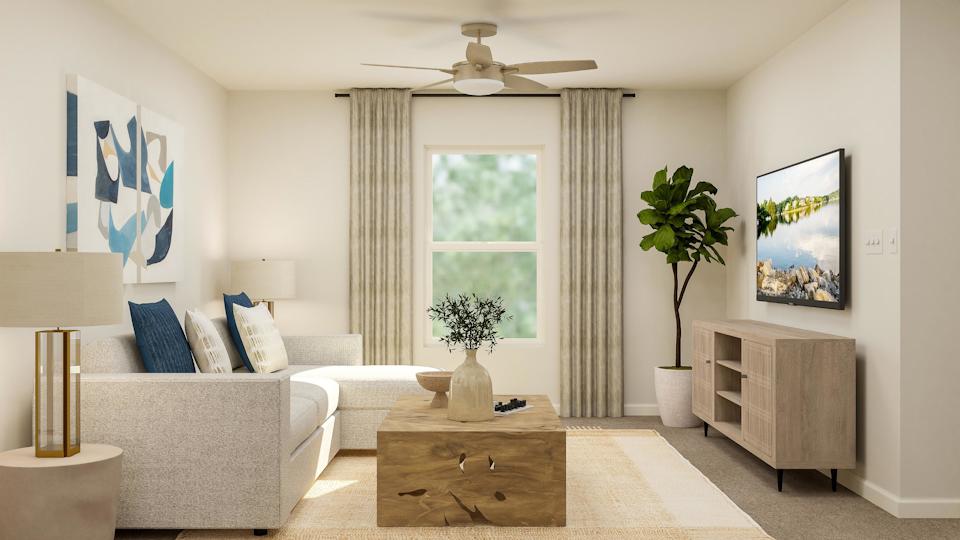 A living room with a couch and a table.