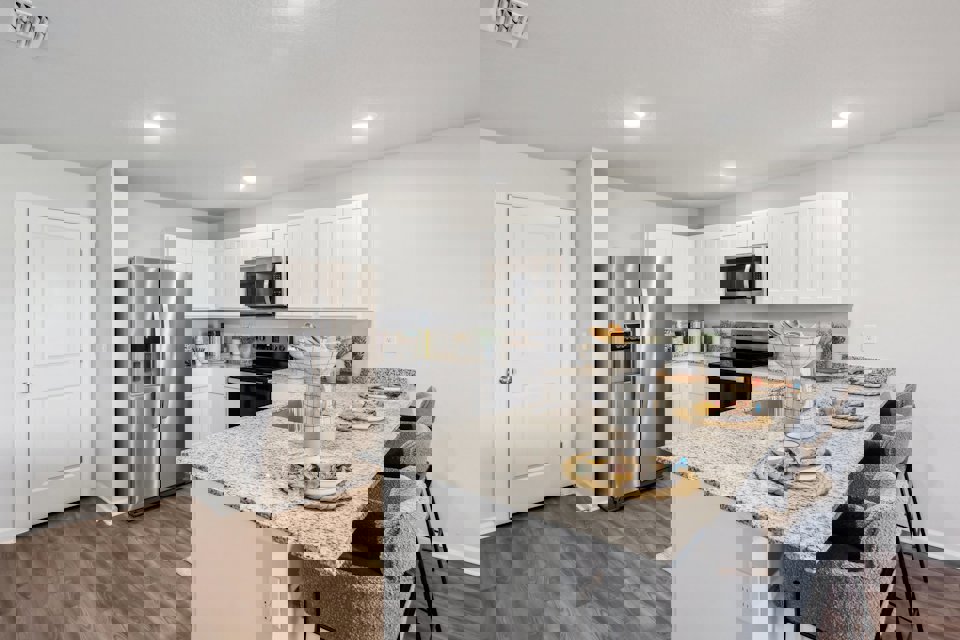 A kitchen with white cabinets.