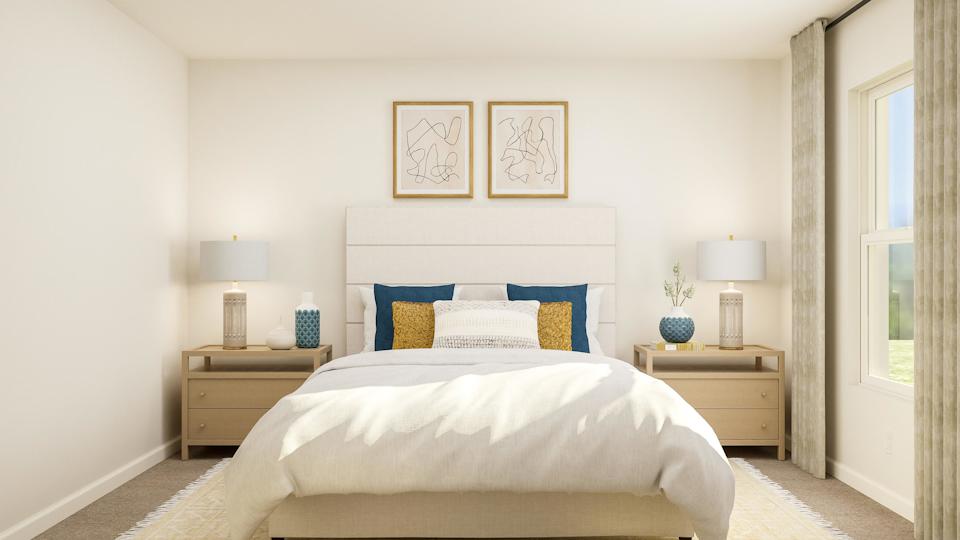 A bedroom with a bed and lamps.