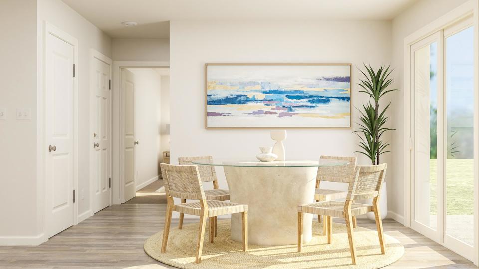 A dining room with a table and chairs.