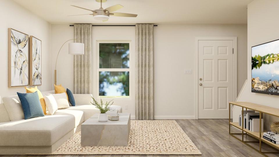 A living room with a couch and a table.