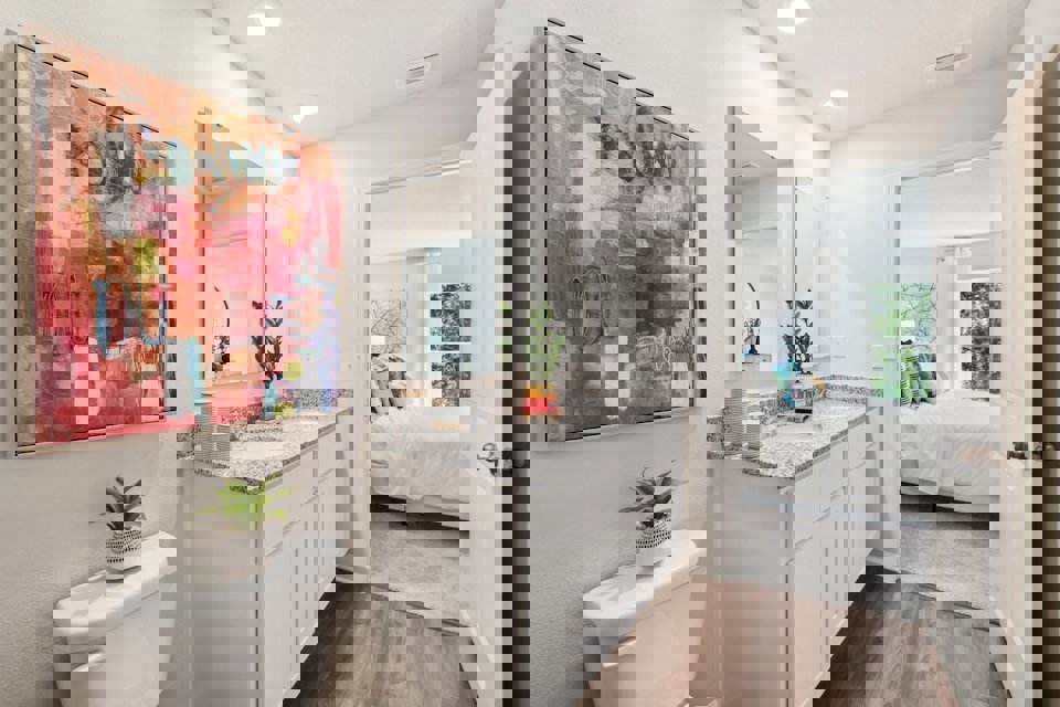 A bathroom with a large mirror.