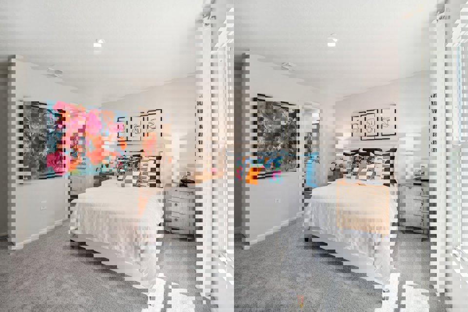 A bedroom with a bed and a lamp.