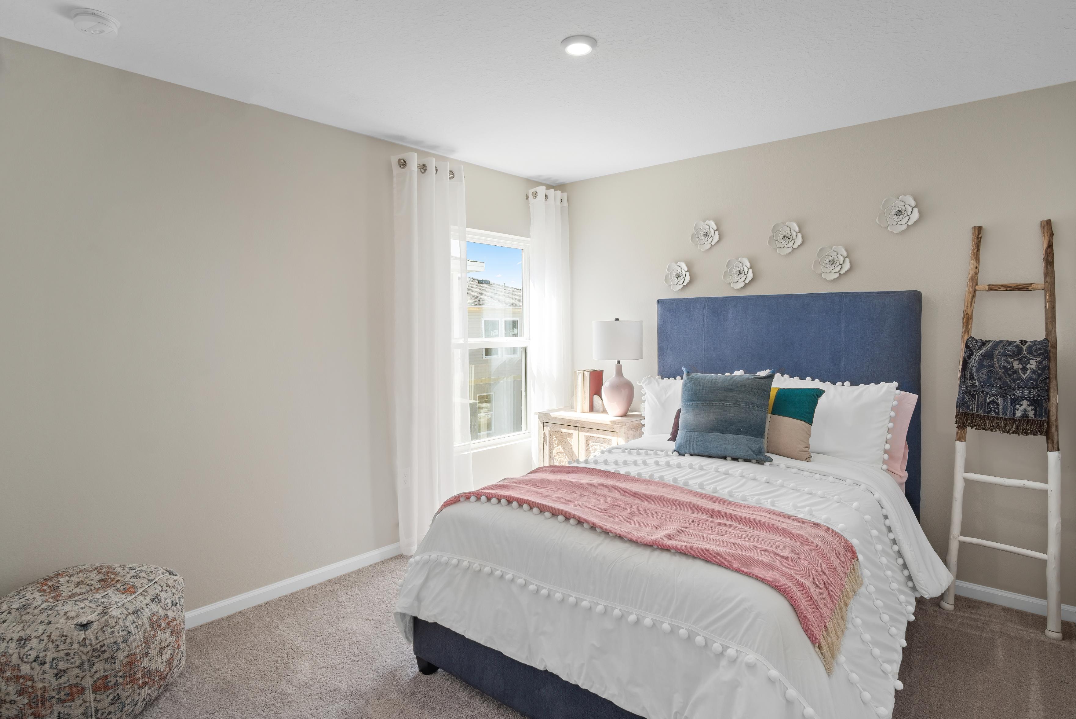 A bedroom with a bed and a window.