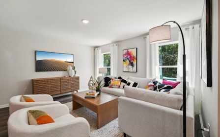 A living room with a couch and a table.