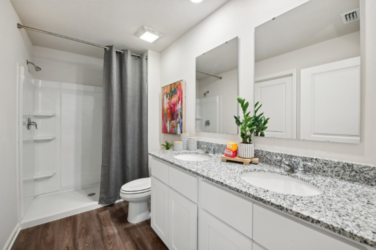 A bathroom with a tub sink and toilet.