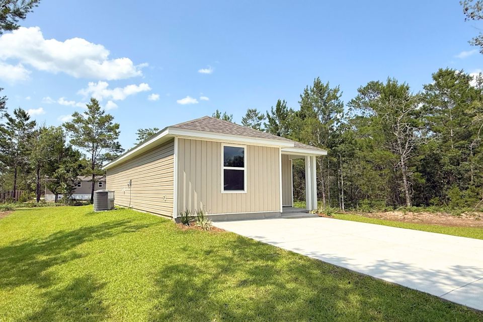 A small house with a driveway.