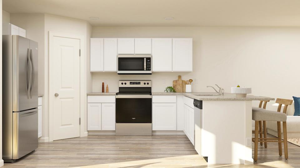 A kitchen with white cabinets.