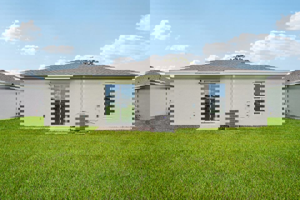 A house with a green lawn.