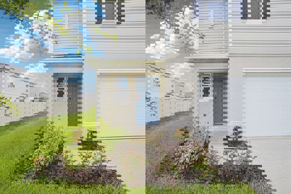 A white house with a garage.