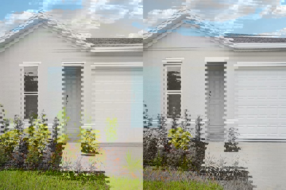 A white house with a blue door.