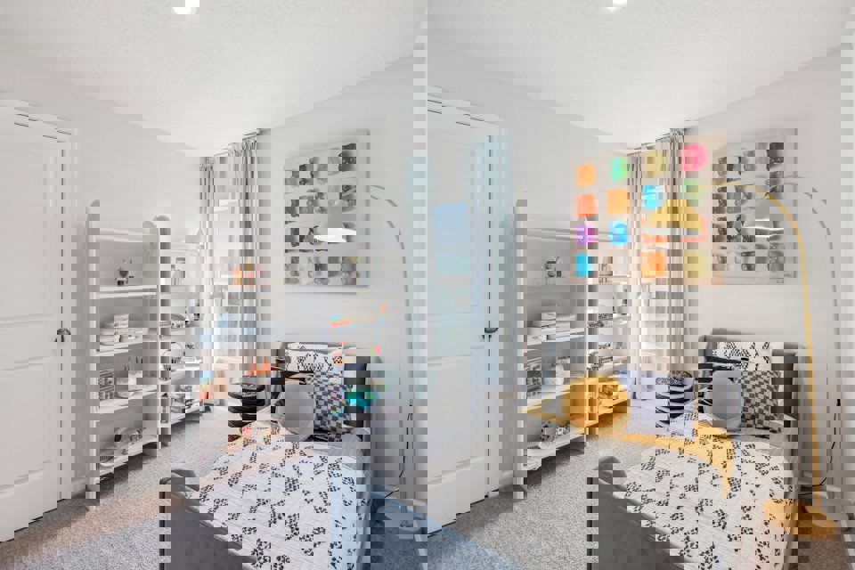 A bedroom with a bed and shelves.