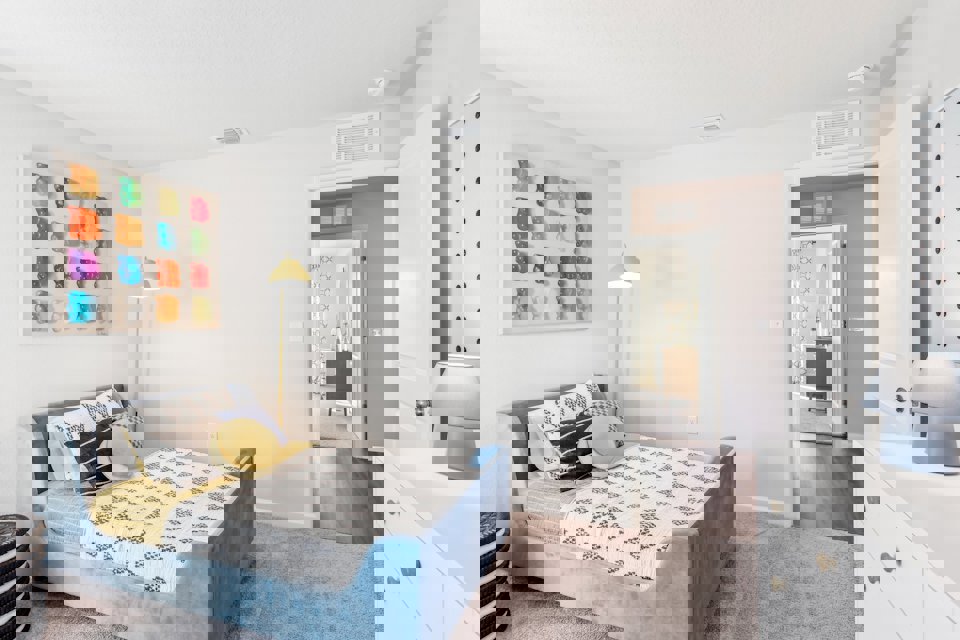 A bedroom with a bed and a lamp.