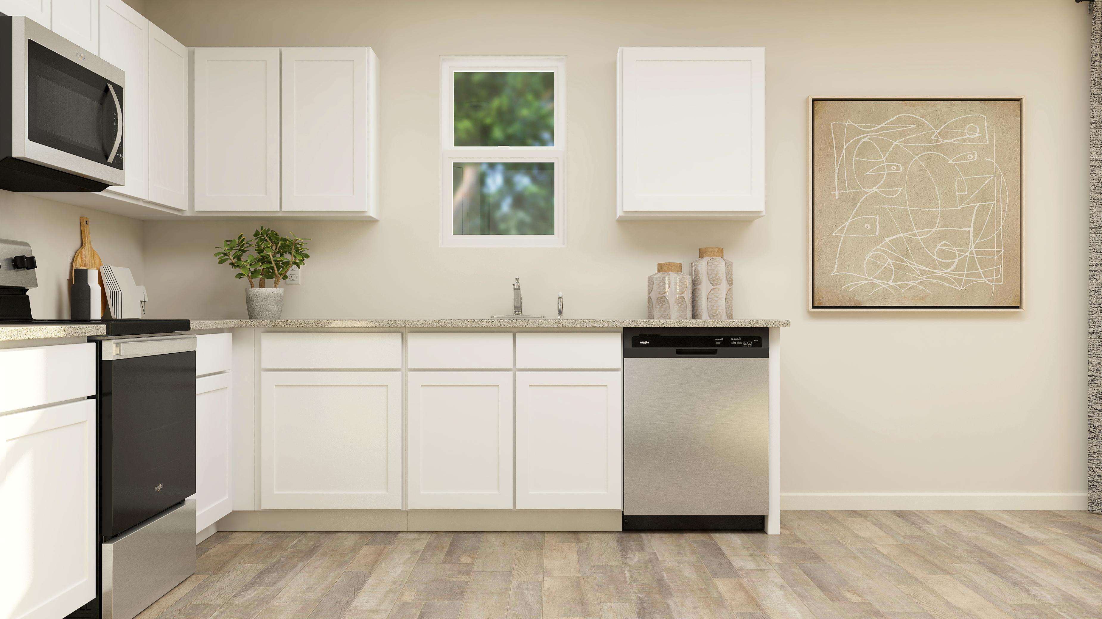 A kitchen with white cabinets.