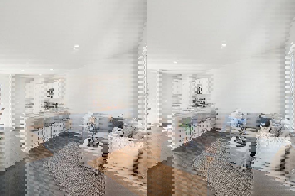 A living room with a dining table and couches.