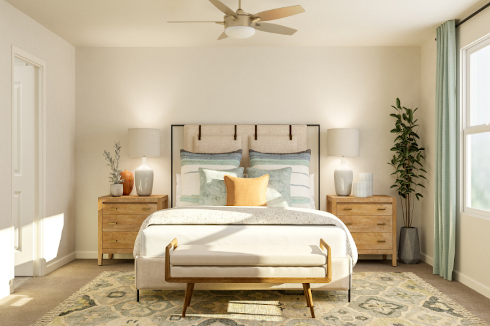 A bedroom with a bed and lamps.