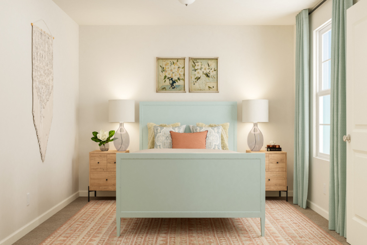 A bedroom with a bed and lamps.