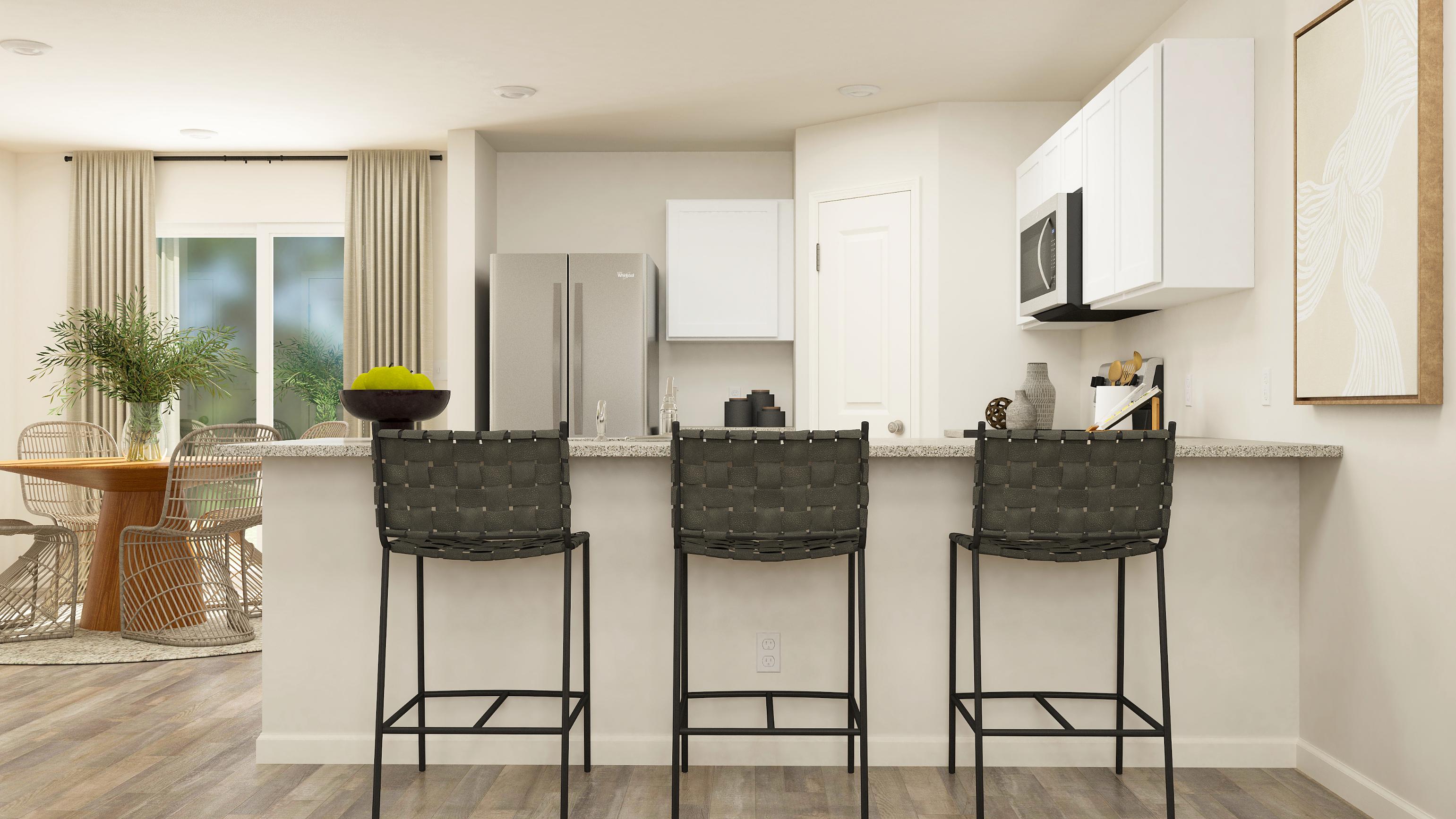 A kitchen with a table chairs and a refrigerator.