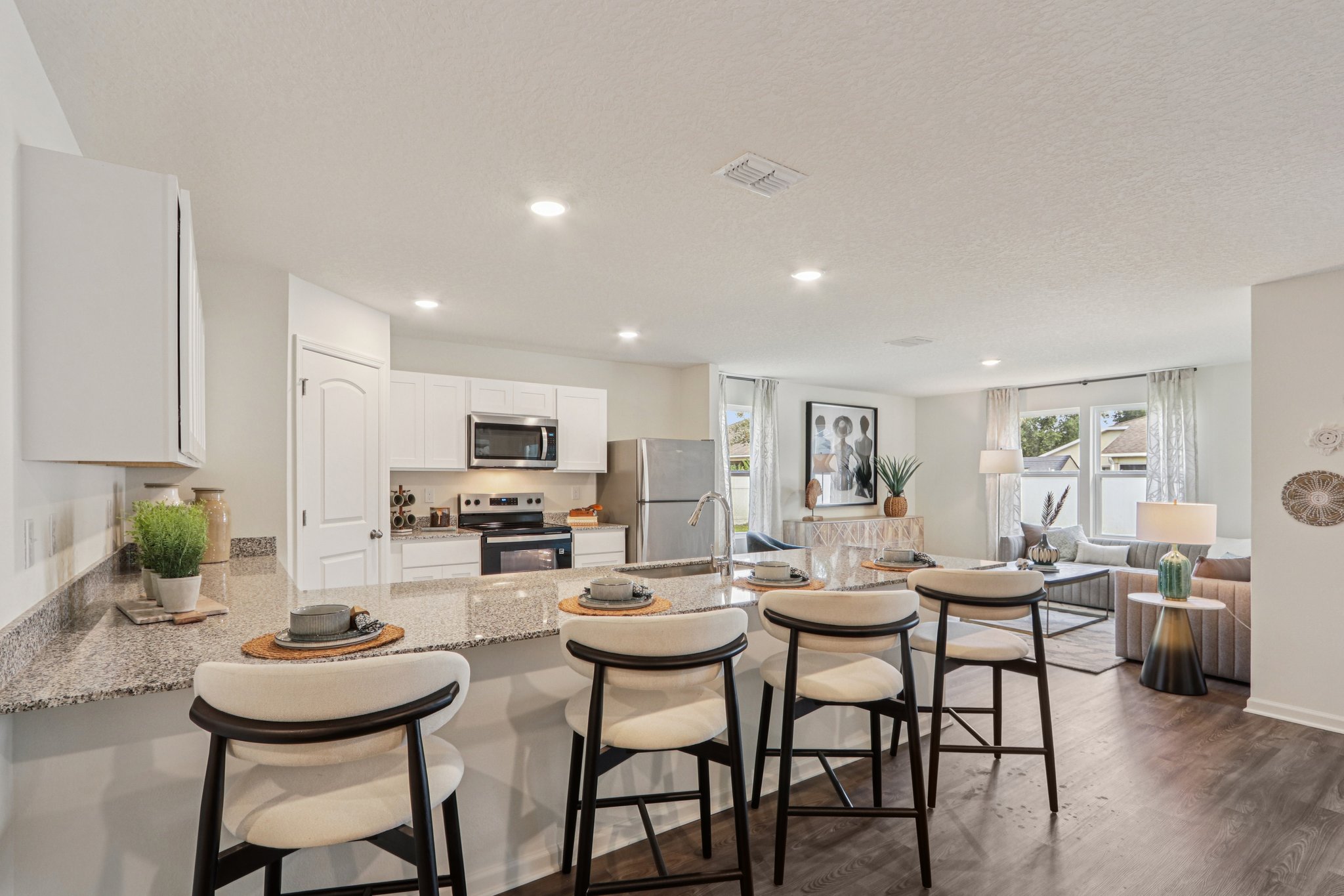 A kitchen with a marble counter.