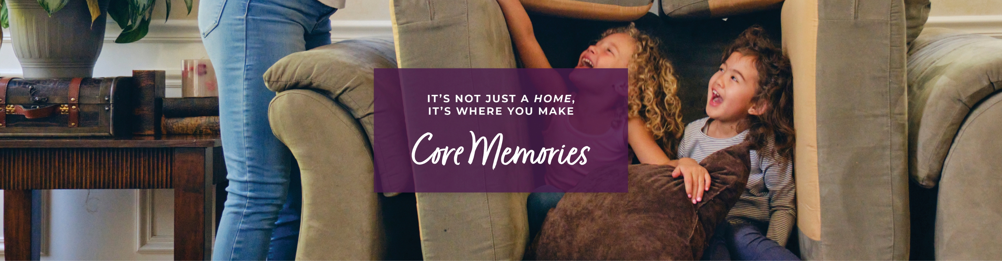 A person sitting on a couch with a sign in front of the.